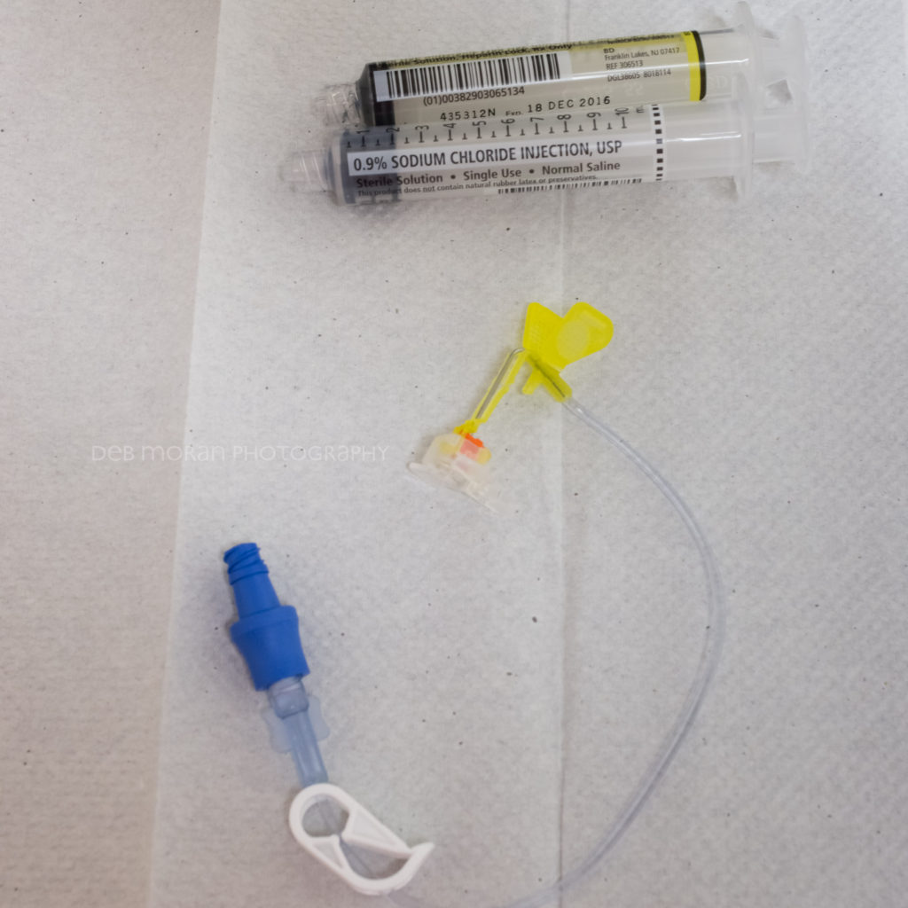 When I'm done with the port for a given day, the nurse flushes it with saline and heparin to keep it from clogging. Then, when the needle is removed from my port, it automatically retracts so no one gets stuck inadvertently. Next time, I'll show you the needle BEFORE it goes in. :)
